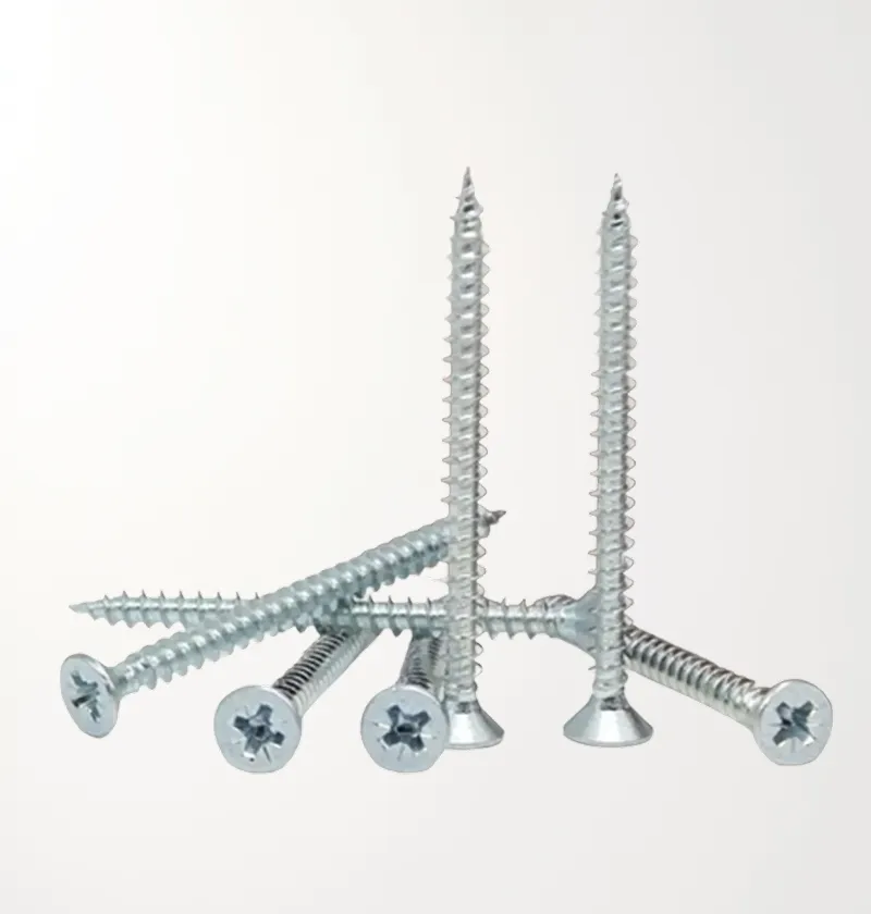 Silver chipboard screws standing and lying on a light surface
